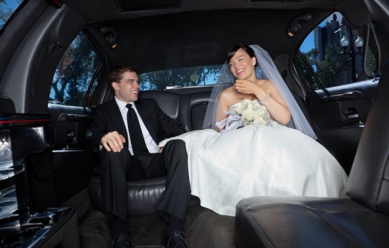 newly wed couple in limousine